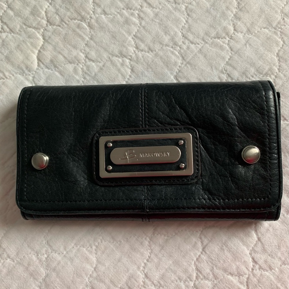 Black leather wallet with cheetah print inside.